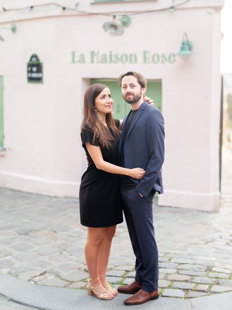 couple stand front of la maison rose during engagement session at montmartre, Paris