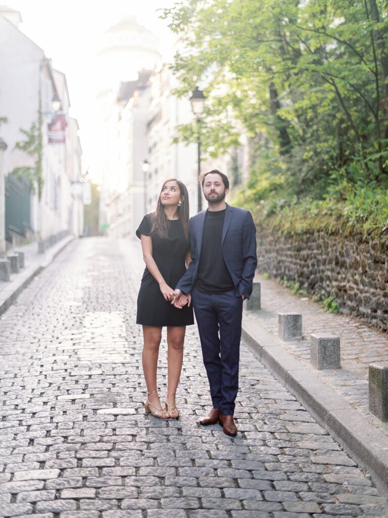 couple stand during engagement session at montmartre, Paris